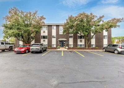Front view of Arbor Hills Apartments showing parking spaces and building entrances