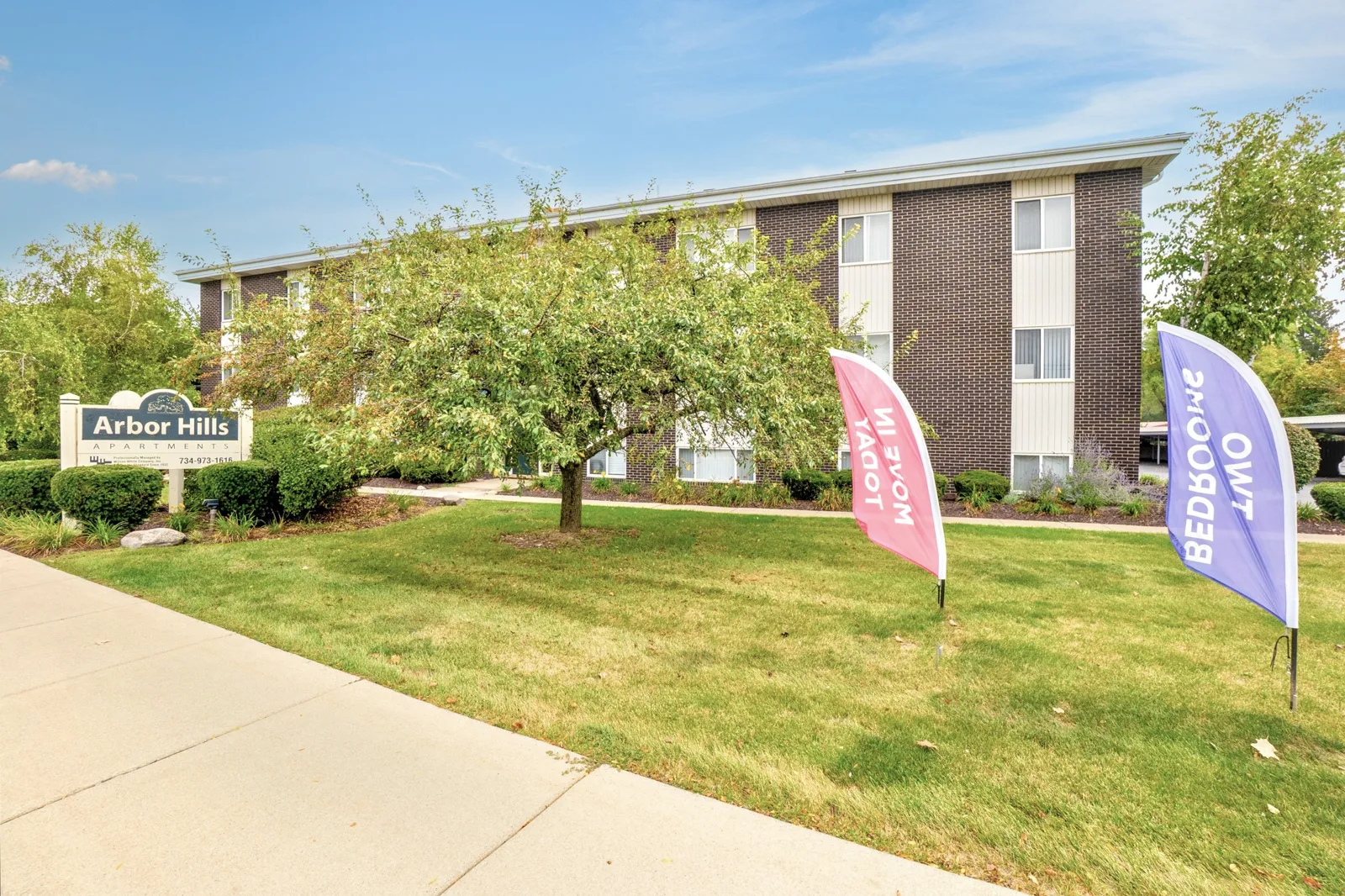 arborhillsapartments_8 Exterior view of Arbor Hills Apartments showing landscaped grounds and residential buildings along the sidewalk